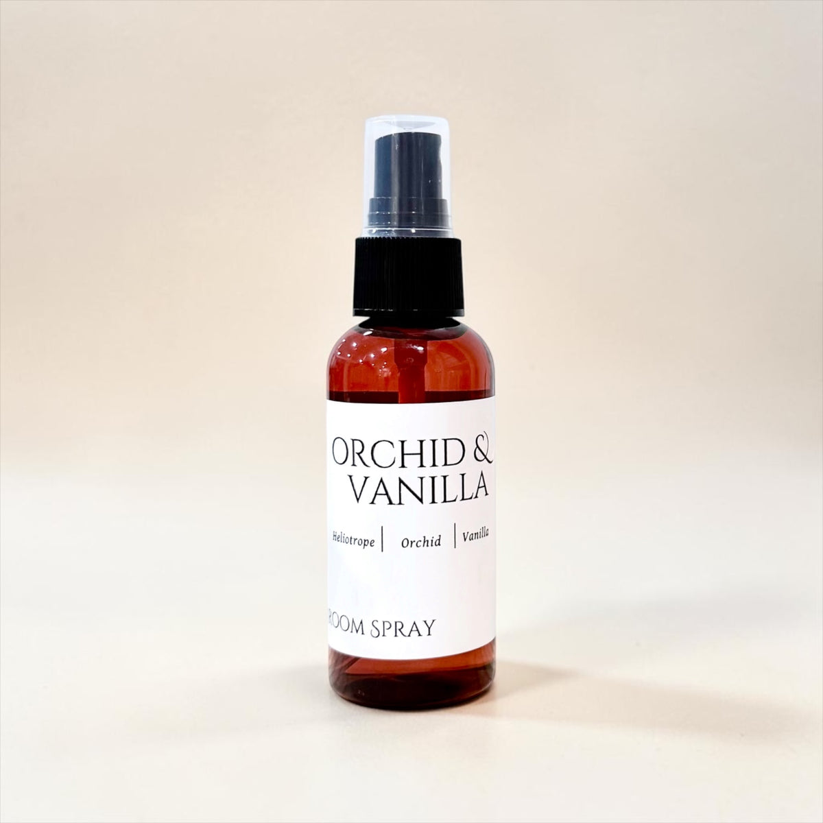 Orchid & Vanilla room spray bottle against a soft warm background