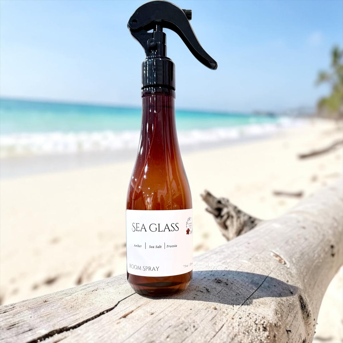 Sea Glass room spray bottle on the beach with ocean waves