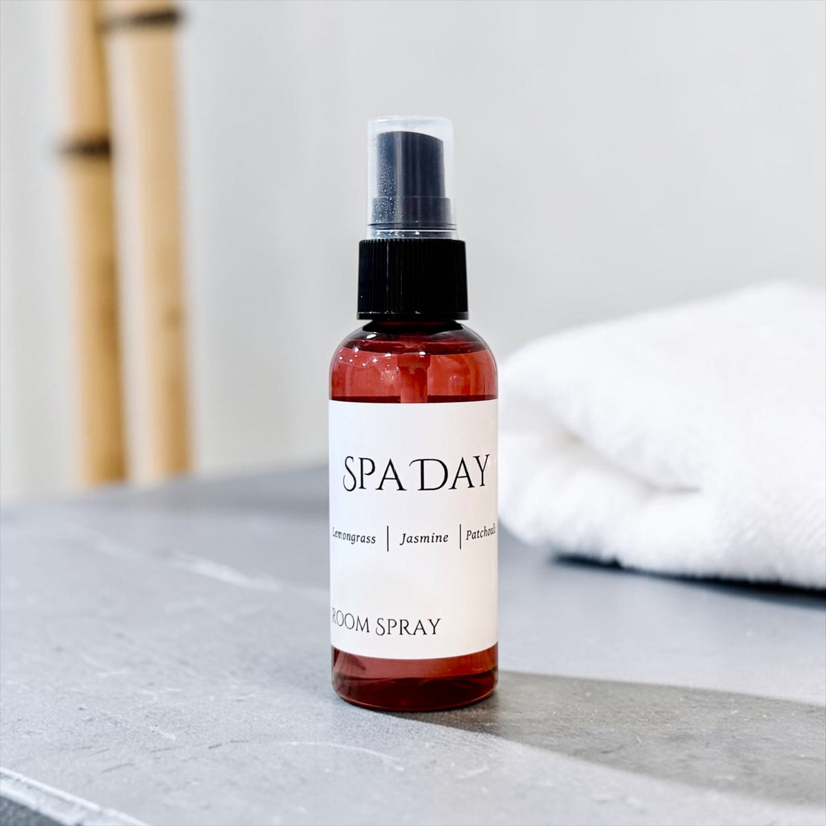 Spa Day room spray bottle with bamboo and a gray stone surface