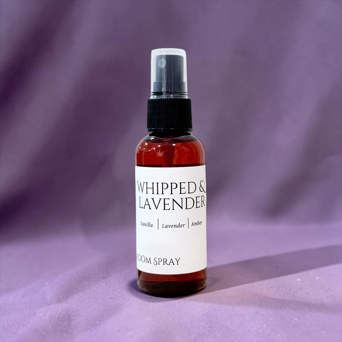 Whipped Lavender room spray bottle against a lavender-purple background