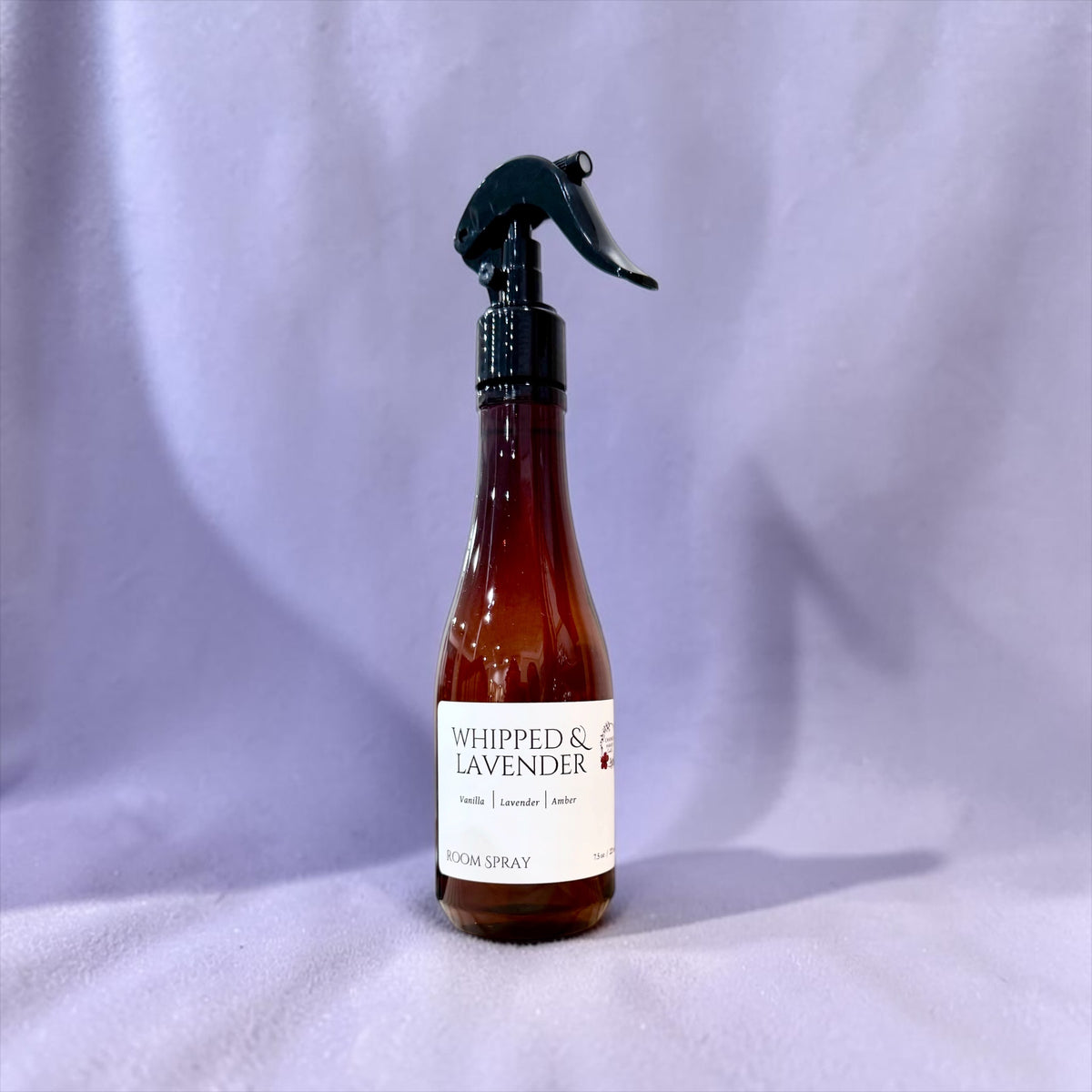 Whipped Lavender room spray bottle against a deep purple background
